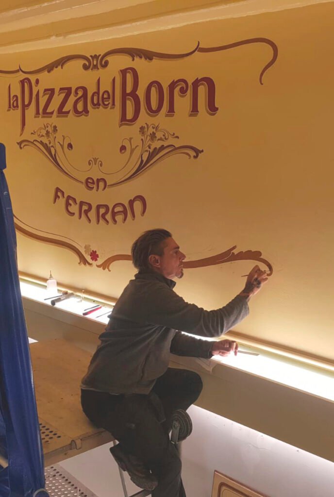 fer pintando a mano un muro